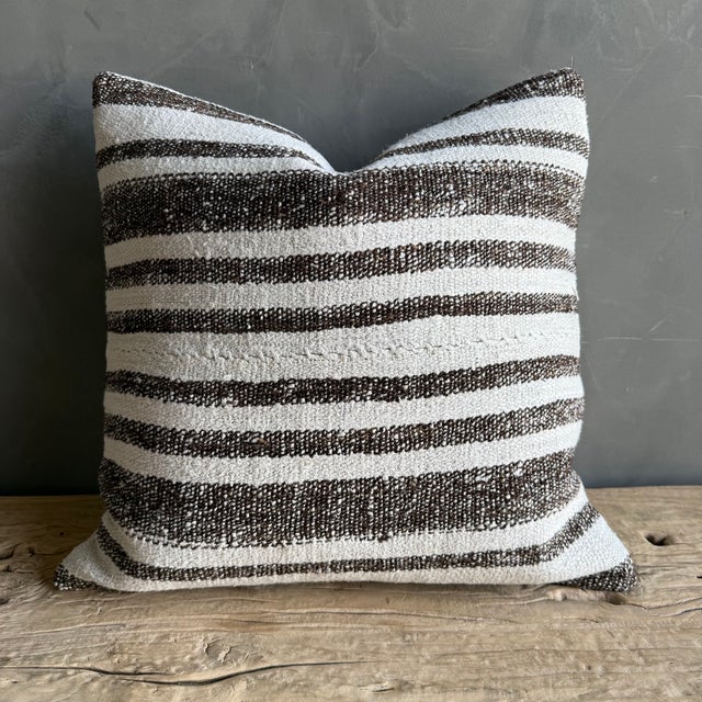 Creamy white hemp rug pillow with stripes. Soft hand, linen blend backing with zipper closure. Spot cleaning is...