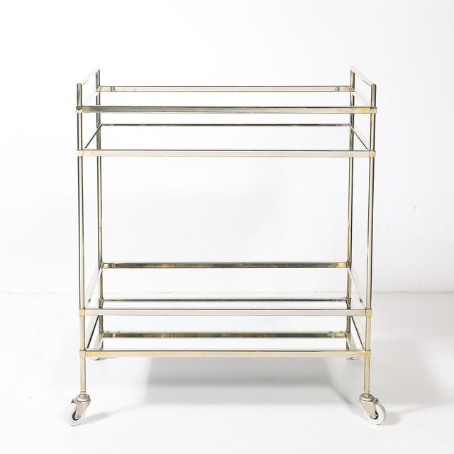 This handsome mid-century modernist two-tier bar cart, crafted in America during the 20th century, is the perfect blend of...