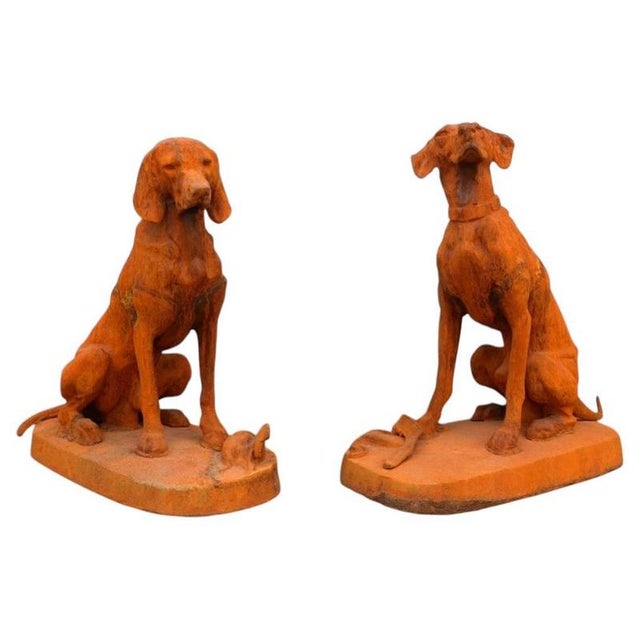 An exceptionally impressive pair of monumental life-size cast iron hunting hound sculptures, based on celebrated 19th-...