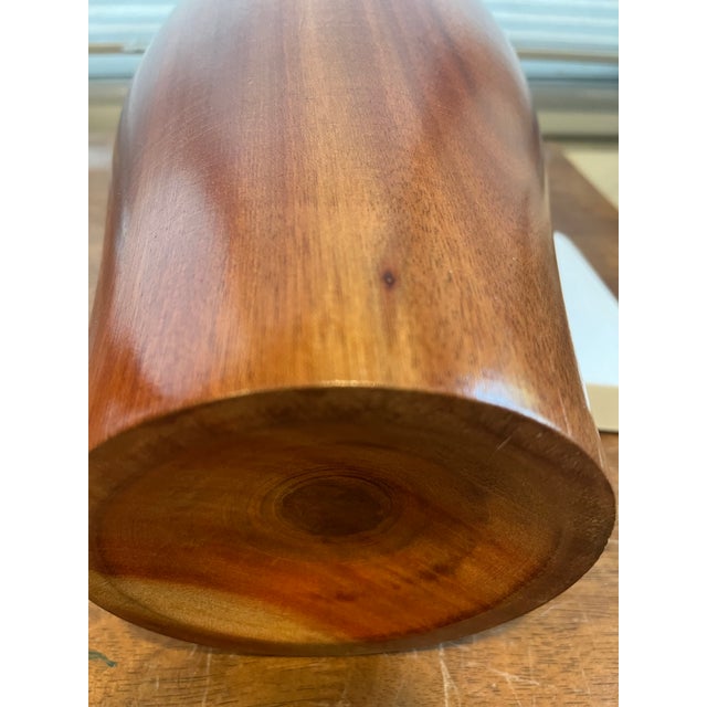 A hand turned tall cylindrical wooden vase probably walnut not marked