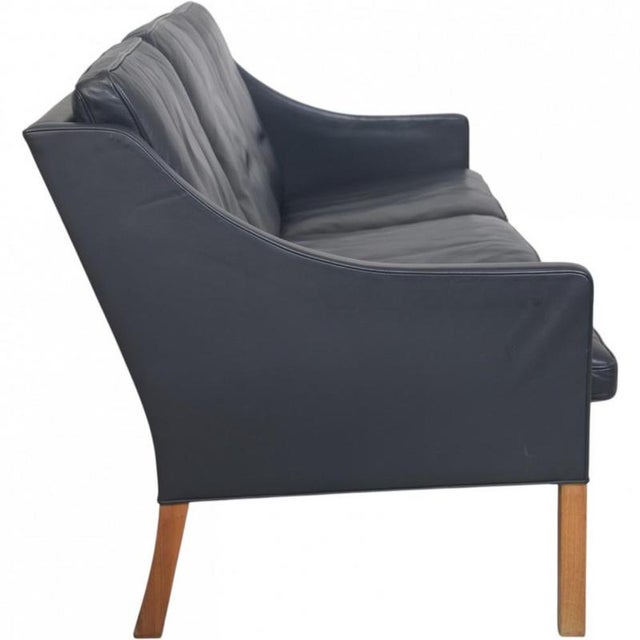 Børge Mogensen 2209 3.seater sofa upholstered in black leather and with legs of teak. The sofa is from the 1980s but was...
