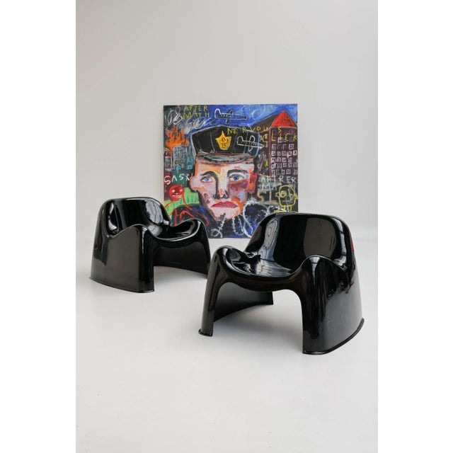 Pair of Toga chairs designed by Sergio Mazza and produced by Artemide. Made of black fiberglass, these chairs are...