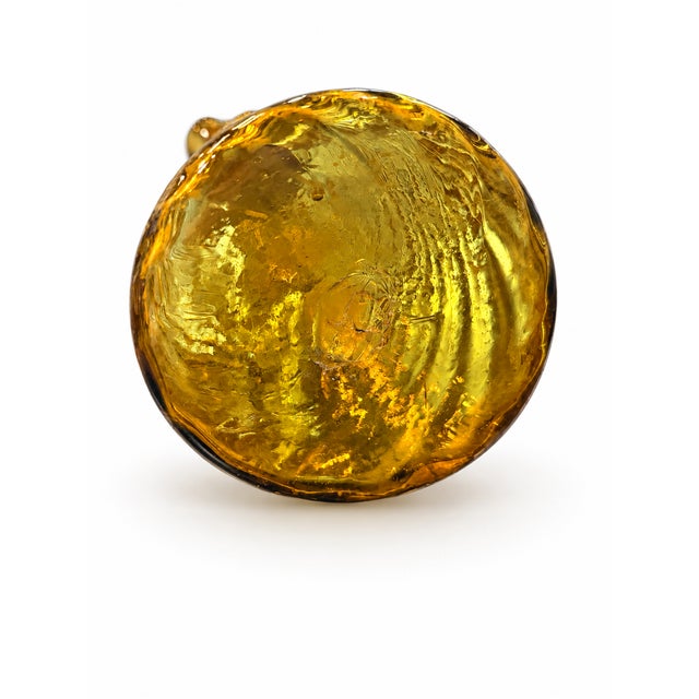A rare and mesmerizing piece of early glassmaking history, this late 19th-century antique vase features a radiant honey-...
