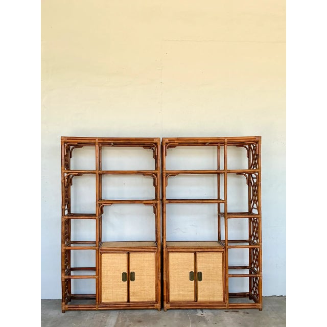 Defined by intricate open latticework, this vintage pair of tall étagères is crafted from bent rattan and tightly woven...