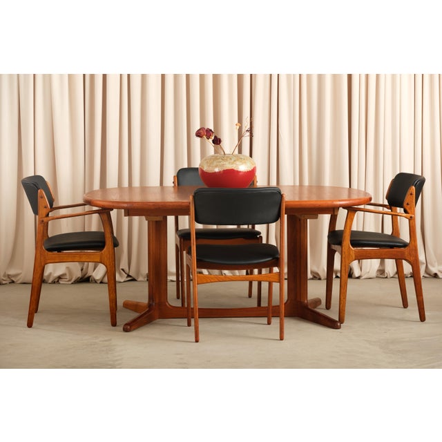 The grain on this table is the first thing you notice, richly figured teak with that warm amber depth that only comes with...