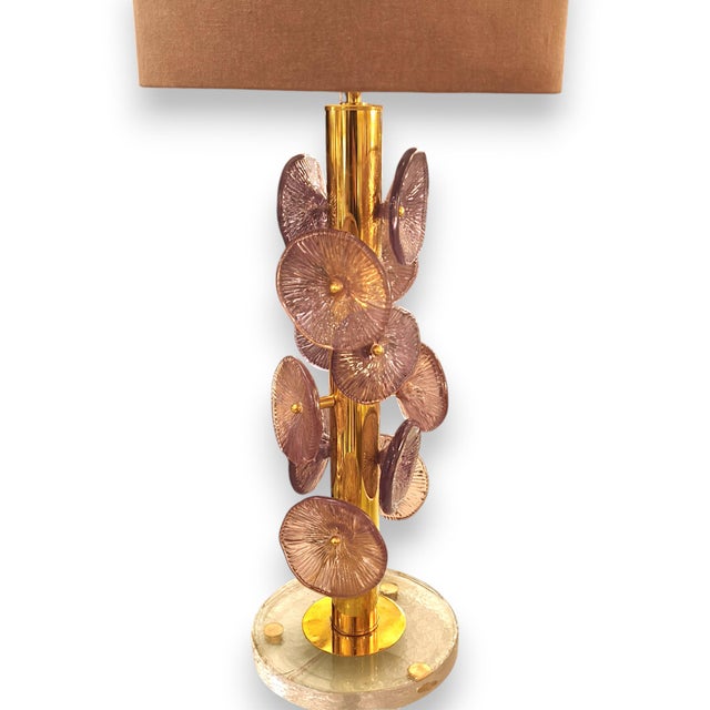 Pair of table lamps with violet Murano glass in the shape of irregular, striated discs. The base is round and made of...