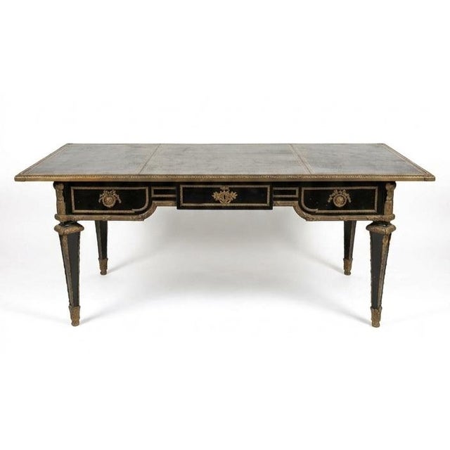 This elegant piece is a classic French Louis XVI style ebonized bureau plat (writing table), known for its clean...