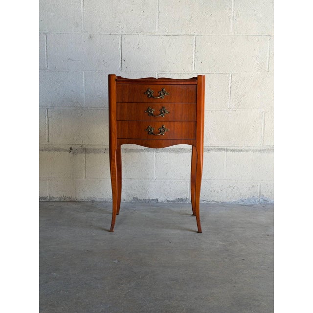 Elegant vintage Danish Modern bedside cabinet crafted in teak, featuring softly curved cabriole-style legs, sculpted...