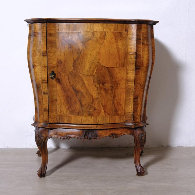 Small mid-20th-century Italian sideboard, bedside table, or bar cabinet in the Baroque style, characterized by carvings...