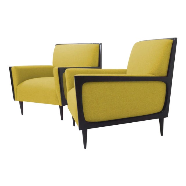 Modern mid-century style lounge chairs. The pair of chairs is newly upholstered and refinished. The chairs are done in a...