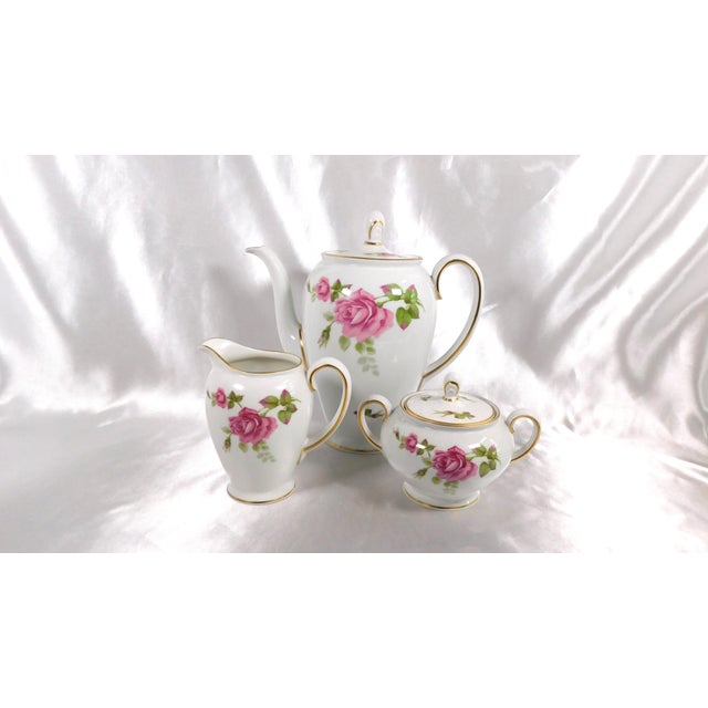 This is a white coffee pot by Rosenthal in the Aida pattern. It has a large pink rose on each side with nice gold trim and...