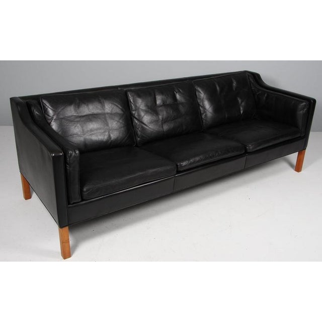 Børge Mogensen three-seat sofa with original patinated black leather upholstery. Legs of teak. Model 2213, made by...
