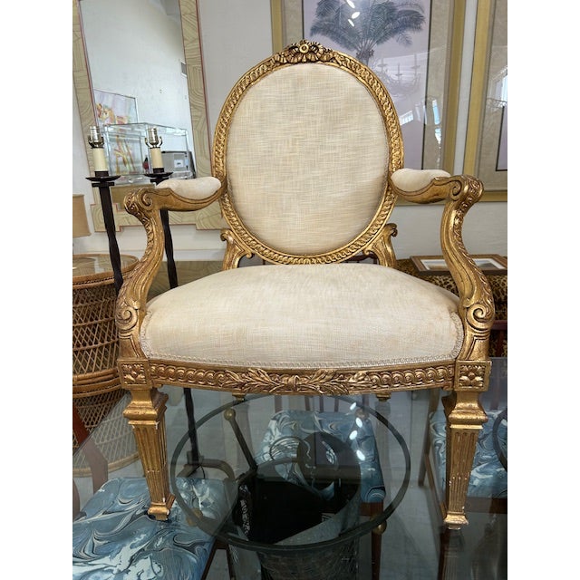 Chic pair of 20th Century Italian wood carved oval back gold gilt chairs to float in your space. Lots of patina.