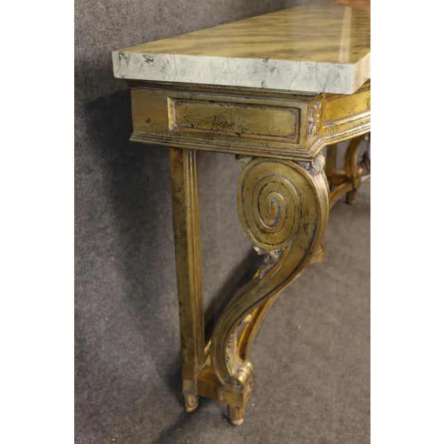 This magnificent French Louis XV style gilded console table captures the grandeur and refinement of 18th-century Parisian...