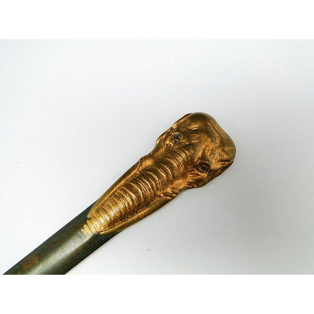 A figural letter knife with a zoomorphic motif depicting an elephant was made in France around 1900-1910. Its condition is...