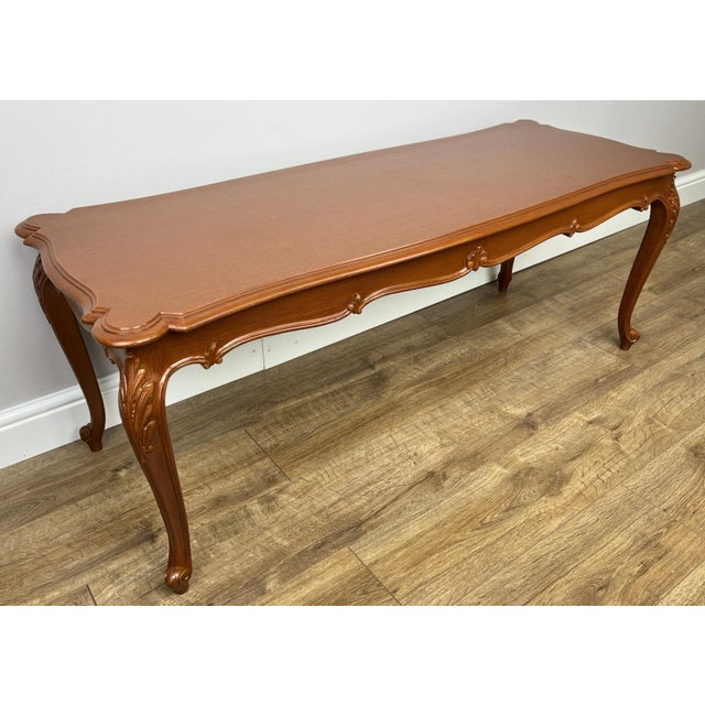 A beautifully styled Vintage French Louis coffee table , featuring elegant curves and decorative carved detailing that...