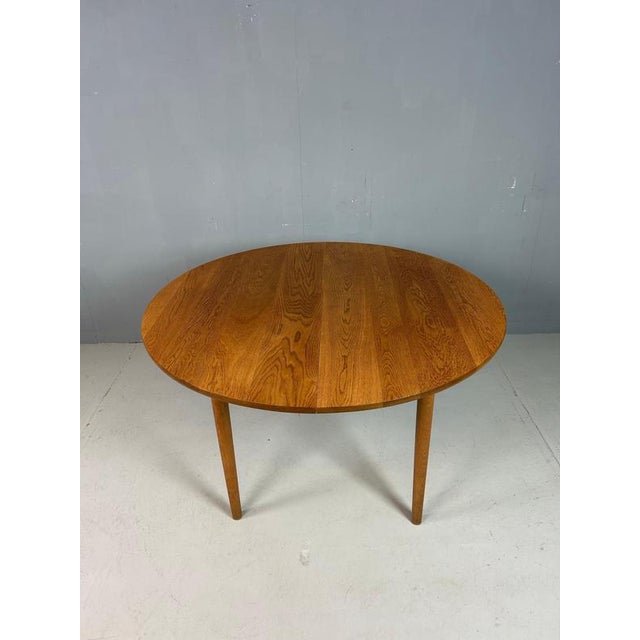 An elegant round dining table designed by Danish master Hans J. Wegner in the 1970s for Andreas Tuck. Crafted in Denmark,...