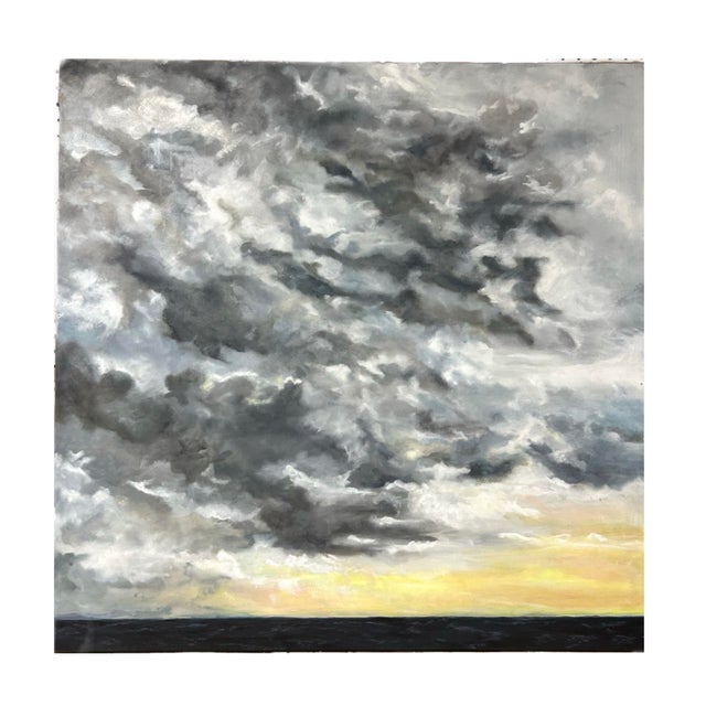 An oil painting of storm clouds with a sense of calmness. Framed in a simple silver metal frame. Measurements: 36x36X2...