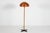 Hans-Agne Jakobsson floor lamp made in the 1970´s. Stem of solid pine wood mounted on a base of metal with black lacquer....