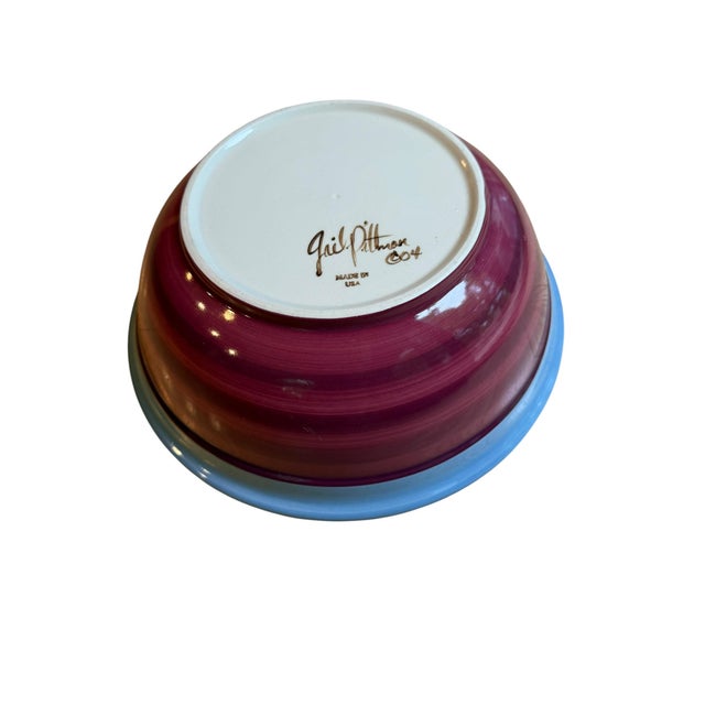 Offering in excellent condition, a hand-painted ceramic serving bowl from renowned Mississippi ceramic artist Gail...