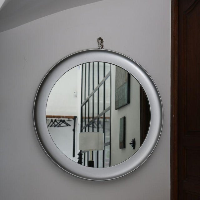 A circular metal mirror, an iconic piece of Italian modernist design, attributed to Sergio Mazza for Artemide and made in...