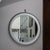 A circular metal mirror, an iconic piece of Italian modernist design, attributed to Sergio Mazza for Artemide and made in...