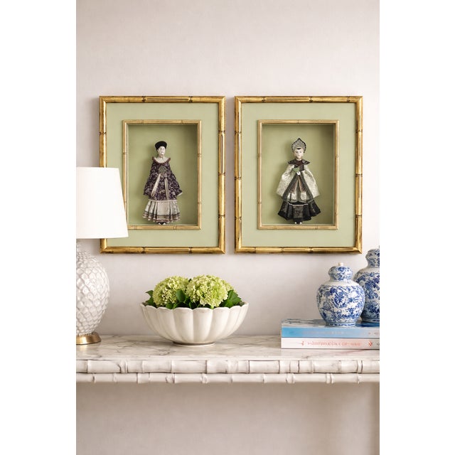 A striking pair of Hollywood Regency–style Chinoiserie figural shadowboxes, dating to the late 20th century. Each frame...