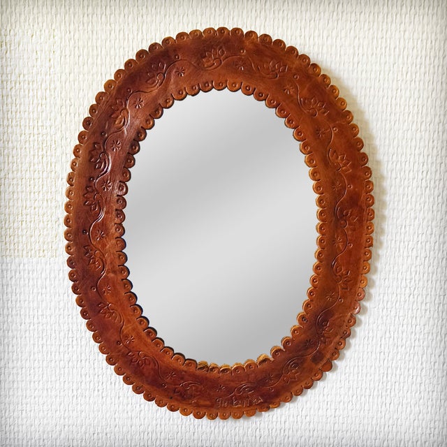 Magnificent oval wall mirror from the 1960s. The frame is made of thick, genuine leather, entirely handcrafted with...