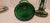 Elegant pair of emerald green glass lusters featuring scalloped bowls and baluster stems, richly decorated with hand-...