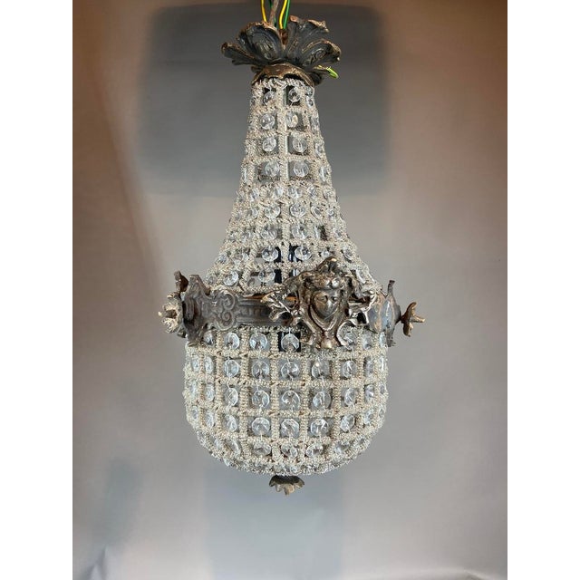 A refined 1960s French Louis XVI-style chandelier, handcrafted in solid bronze with a distinctive charcoal patina. This...
