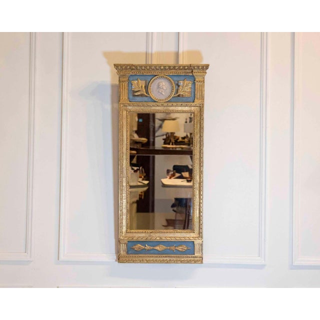 This elegant Swedish mirror dates to the early nineteenth century and reflects the refined neoclassical aesthetic...