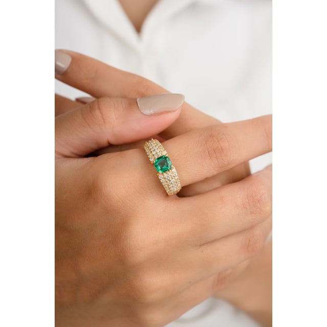 Experience timeless elegance with our 18K cushion cut center stone emerald wedding ring, adorned with chunky diamonds....