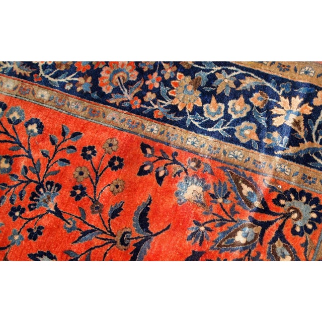 Handmade antique Sarouk rug in original good condition. The rug has been made in the beginning of 20th century in bright...