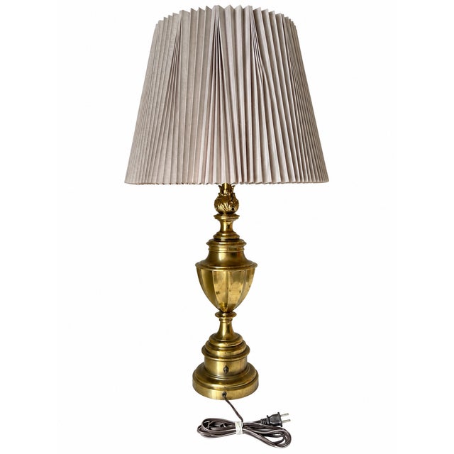 Standing 35 inches high, this Stiffel table lamp features a classical trophy-urn silhouette with a fluted central body,...