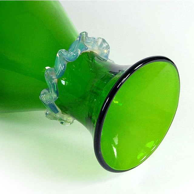 This decorative wine or water carafe is made of body-tinted glass in a beautiful emerald green. Decorated with a delicate...