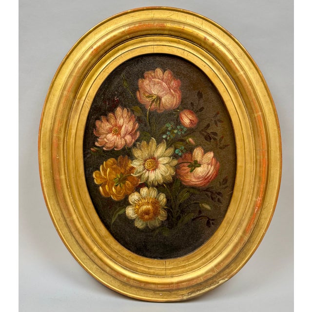 Pair of oval floral still lifes from the mid-19th century, on canvas mounted on panel, in beautiful gilt frames. A...