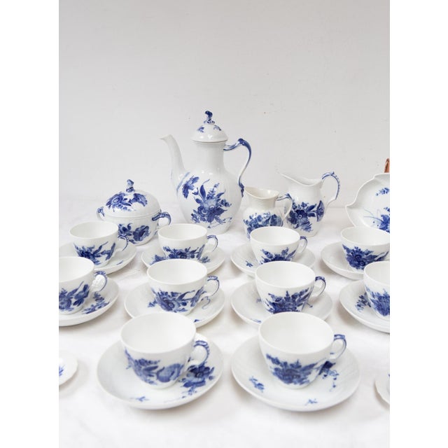 This 11-piece coffee set from the Danish firm Royal Copenhagen, part of their "Blå Blomst" (Blue Blossom) collection, is a...