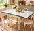 Charming vintage expandable kitchen table featuring a classic white porcelain enamel top with contrasting black trim and a...