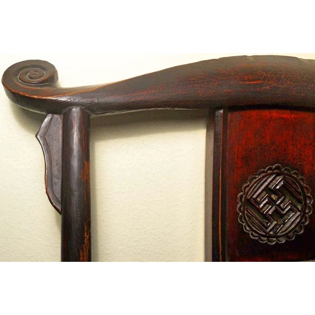 This style of chair is known as "official's hat chair" because the projections over the rear stiles resemble the knobs on...