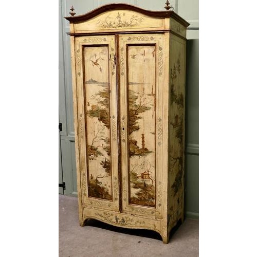 Antique Painted Chinoiserie Lacquer Cupboard Decorated with Outdoor Scenes The cupboard is in dark cream and decorated...