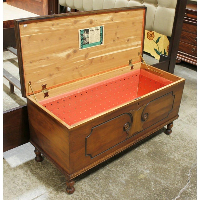 Crafted from cedar with a warm medium-tone finish, this piece features an ornate front panel with carved detailing,...