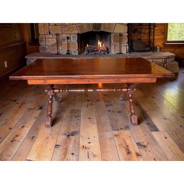 This stunning vintage 1970s solid wood trestle table features an ornate X-brace base, masterfully restored to highlight...