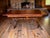 This stunning vintage 1970s solid wood trestle table features an ornate X-brace base, masterfully restored to highlight...