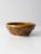 This is a vintage studio pottery bowl. Signed by the artist, the handmade bowl has a textural design with a ochre glaze.