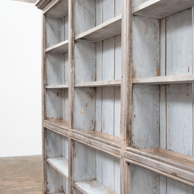 Large painted wooden bookcase, early 19th century. The front features 15 large open niches with display shelves. The back...