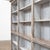 Large painted wooden bookcase, early 19th century. The front features 15 large open niches with display shelves. The back...