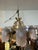this vintage art deco chandelier featuring intricate brass detailing and frosted glass shades.