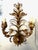 Pair of elegant, gilded scroll and leaf two-light sconces. The intricately crafted leaves grow naturally from the frame,...
