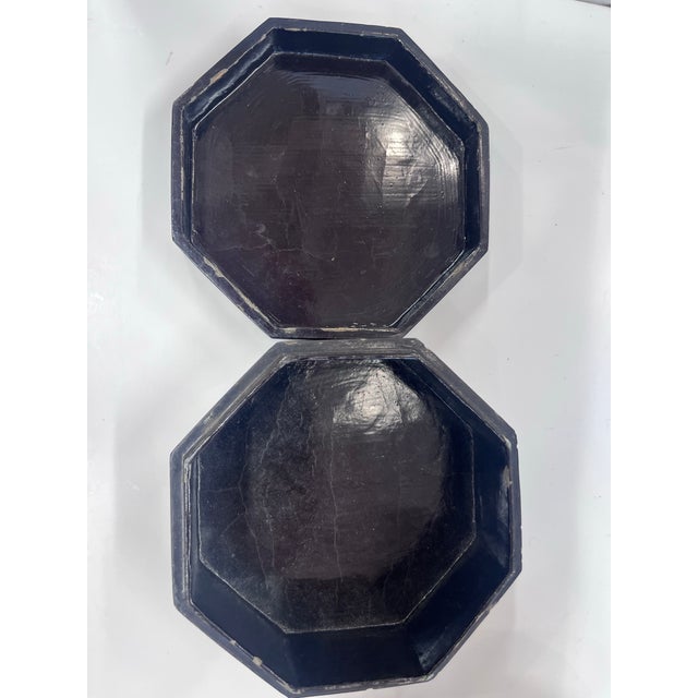 Black lacquered decorative box featuring an intricate mother-of-pearl inlay