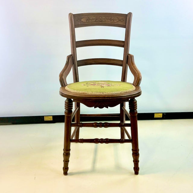 This is a lovely piece of Americana Folk Art. The walnut chair is handcarved with a decorative top rail on the back rest....